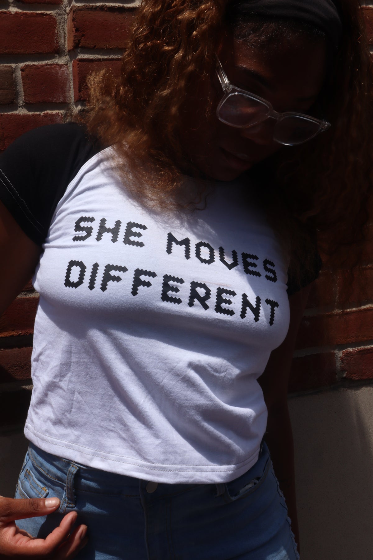 “SHE MOVES DIFFERENT” Cropped Raglan Tee